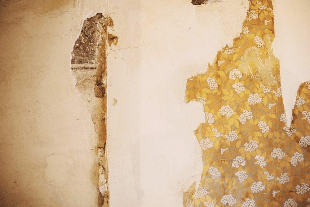 Old wallpaper over bare plaster