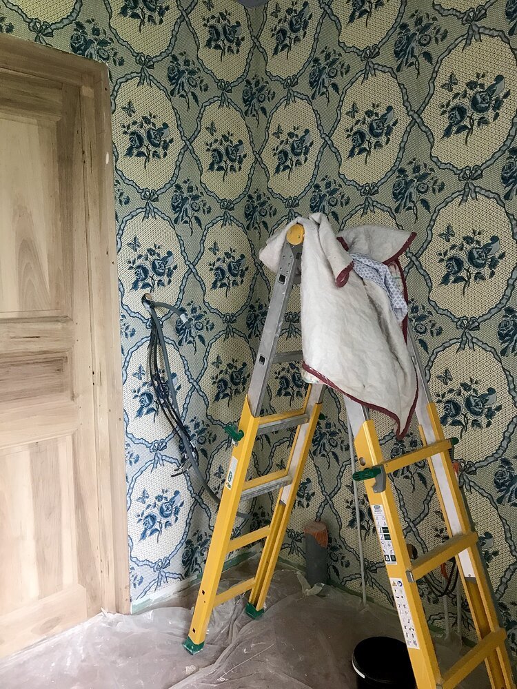 Blue floral paper during the work, a ladder against it