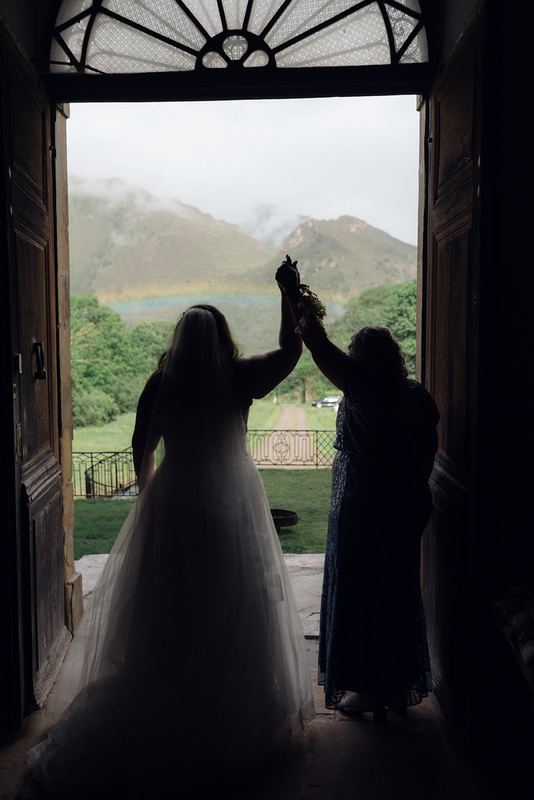 Two silhouettes in the great doorway, the mountains beyond